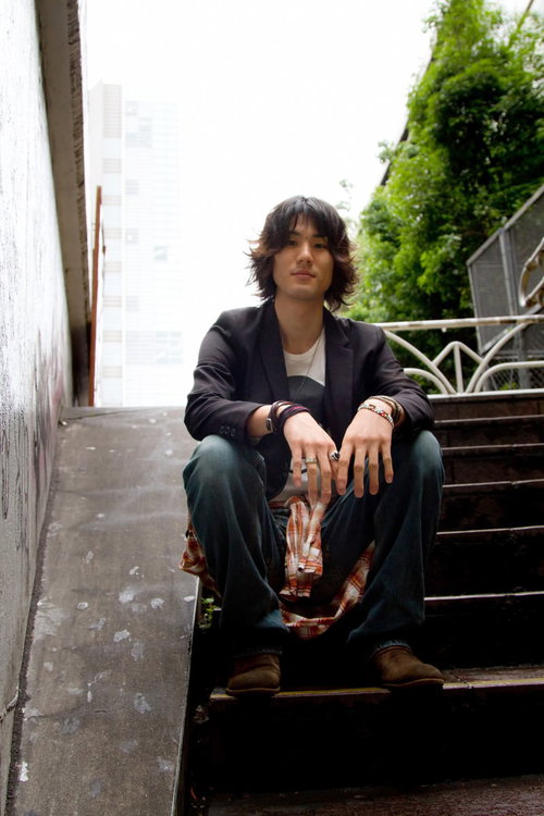 階段に座り街を見下ろす男性のポートレート