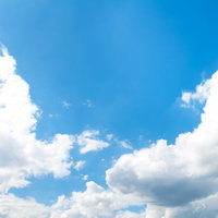 澄んだ青空に浮かぶ大きな雲の写真