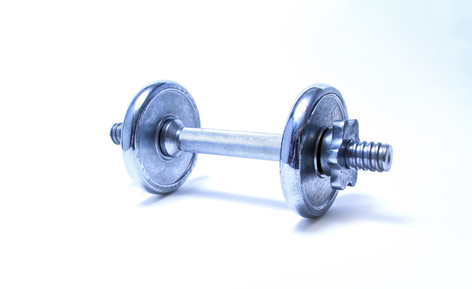 黒い床の銀色のダンベル