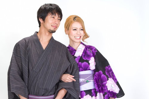 笑顔で腕を組む浴衣の男女の全身