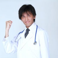 白衣を着てガッツポーズで喜ぶ笑顔の医師の写真