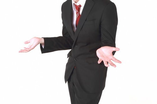 「why?」のジェスチャーをするビジネスマン