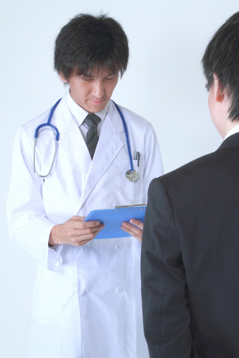 カルテを確認する真剣な担当医［モデル：ACE］