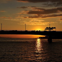 夕暮れ後の薄暗い空と静かな波が打ち寄せる浜辺の写真