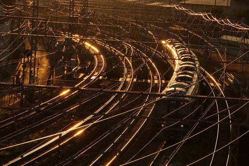 地方の小さな駅でスマホを見る女性