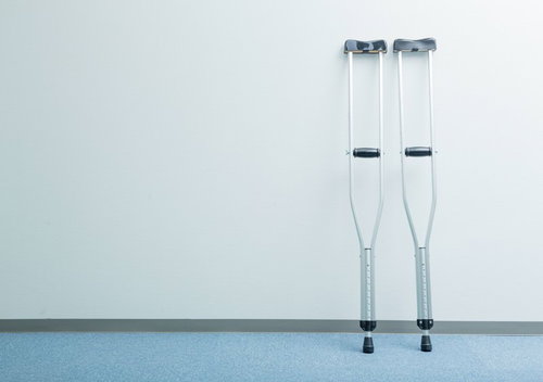 廊下に置かれた2本の白い松葉杖、げんき堂整骨院でのリハビリ風景