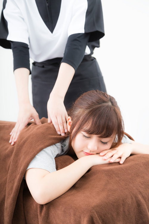 マッサージ施術を受けてリラックスし寝てしまう女性