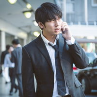 街中で偶然初恋の女性を発見。しかし、当時の面影はなかった--電話で報告する男性記者の写真