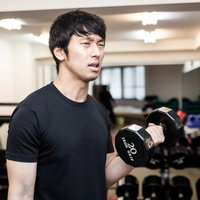 ダンベルカールで上腕二頭筋を鍛える男性トレーニングの写真