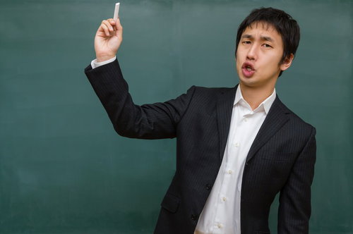 黒板の前でチョークを生徒に投げつける学級崩壊風の先生