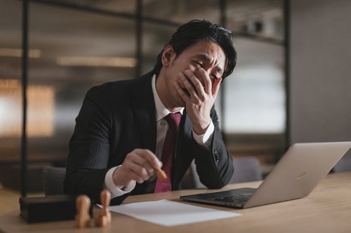始末書に判をする疲弊した会社員の机上風景