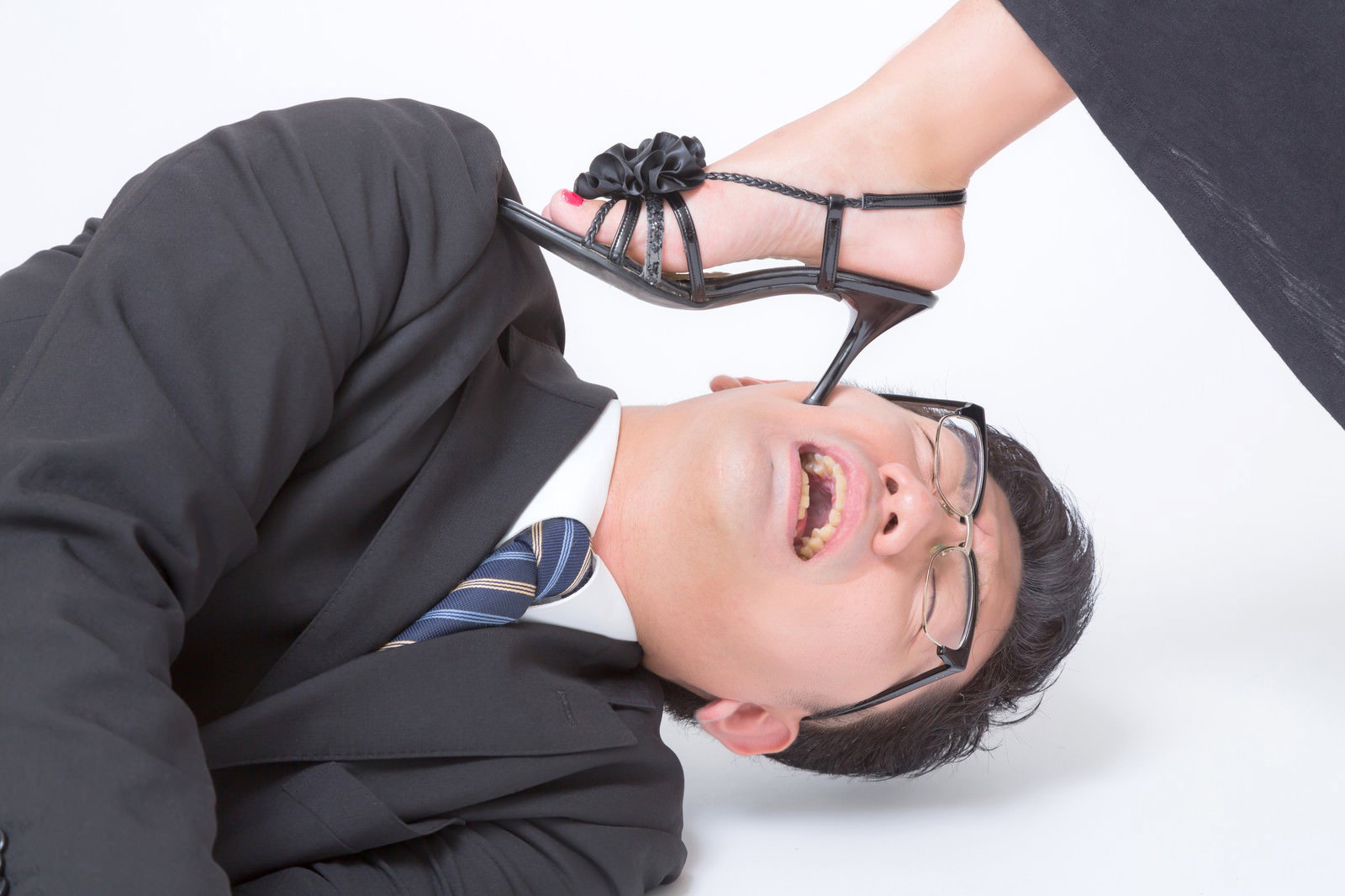 寝落ちした男性の顔の上にヒールの足がある様子［モデル：OZPA］