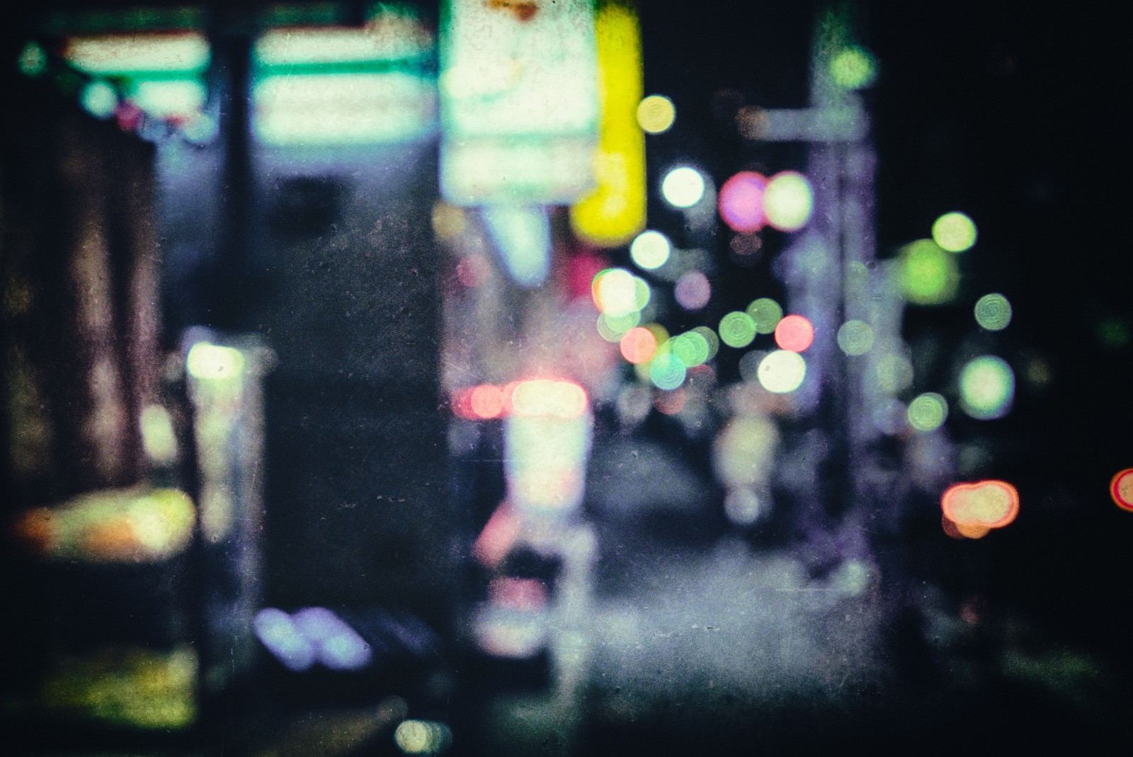 夜の街灯や看板がボケてノイズ感ある玉ボケ夜景