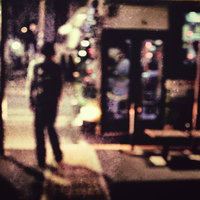 夜道人（ノイズ）- フィルムノイズ入り夜間繁華街の不気味な人影の写真