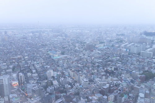 霧に包まれた住宅街の街並み、マンションとビルが密集する都市風景