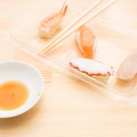 透明な皿に盛られたエビとタコとイカの握り寿司の写真