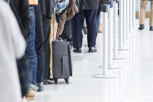People lining up at the airport entrance gate