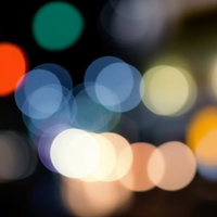 赤や青の光が浮かぶ夜の玉ぼけの写真