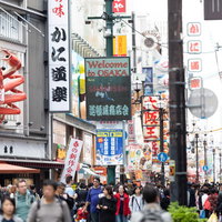 人で溢れる道頓堀商店街の繁華街風景と賑わう観光スポットの写真