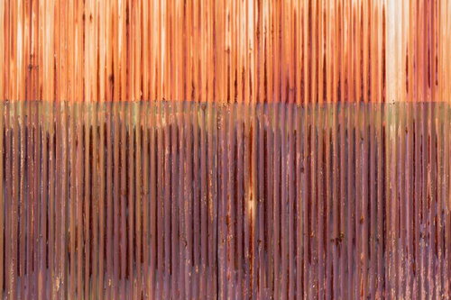 上部が暖色で下部が寒色に変化する錆びたトタンのテクスチャー