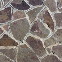 不規則に配置された自然石の乱雑な石壁のテクスチャの写真