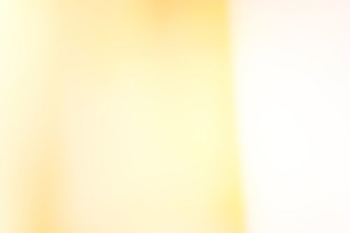 黄色い光のグラデーションテクスチャー背景