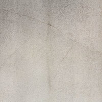 細かい粒やひび割れが見えるコンクリート表面のテクスチャーの写真