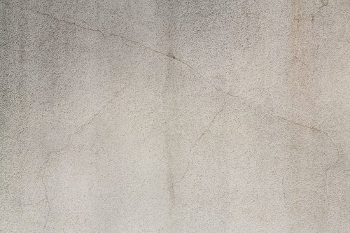 細かい粒やひび割れが見えるコンクリート表面のテクスチャー