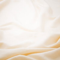 波打つクリーム色の柔らかい布地の写真