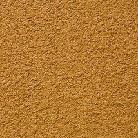 古い建築物のオレンジ色に塗られた壁の質感の写真