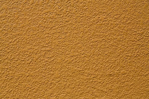 古い建築物のオレンジ色に塗られた壁の質感