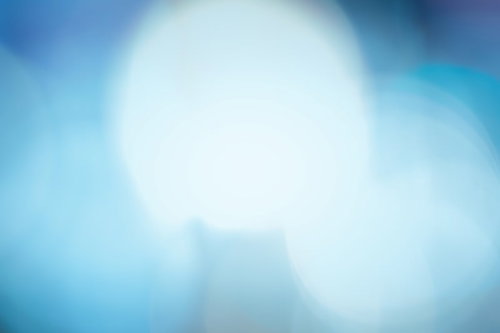 青く寂しい光のボケと光線 中央から放射状に広がる光の粒子