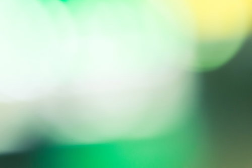 緑色のボケた光とグラデーション背景