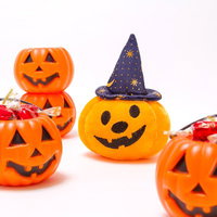 オレンジ色のハロウィンかぼちゃ容器とお菓子の写真