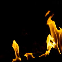 黒背景に映るメラメラと揺らぐ炎の火の躍動的な動きの写真