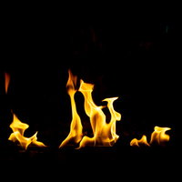 黒い背景に立ち上がるメラメラと揺らぐ炎の炎のテクスチャーの写真