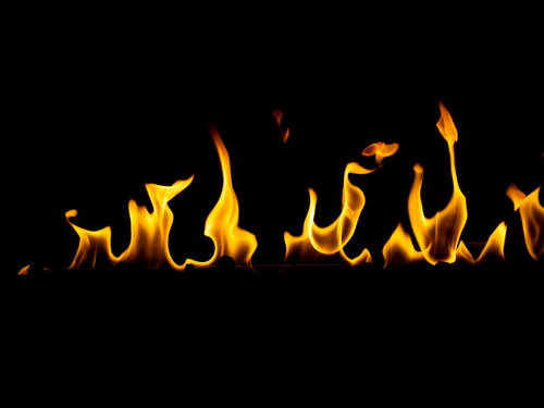 黒背景に燃え上がる火炎、エネルギッシュな炎