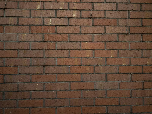 赤茶色に積み重ねたレンガブロックの壁のテクスチャー