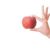 赤いAppleを片手で持った手の写真