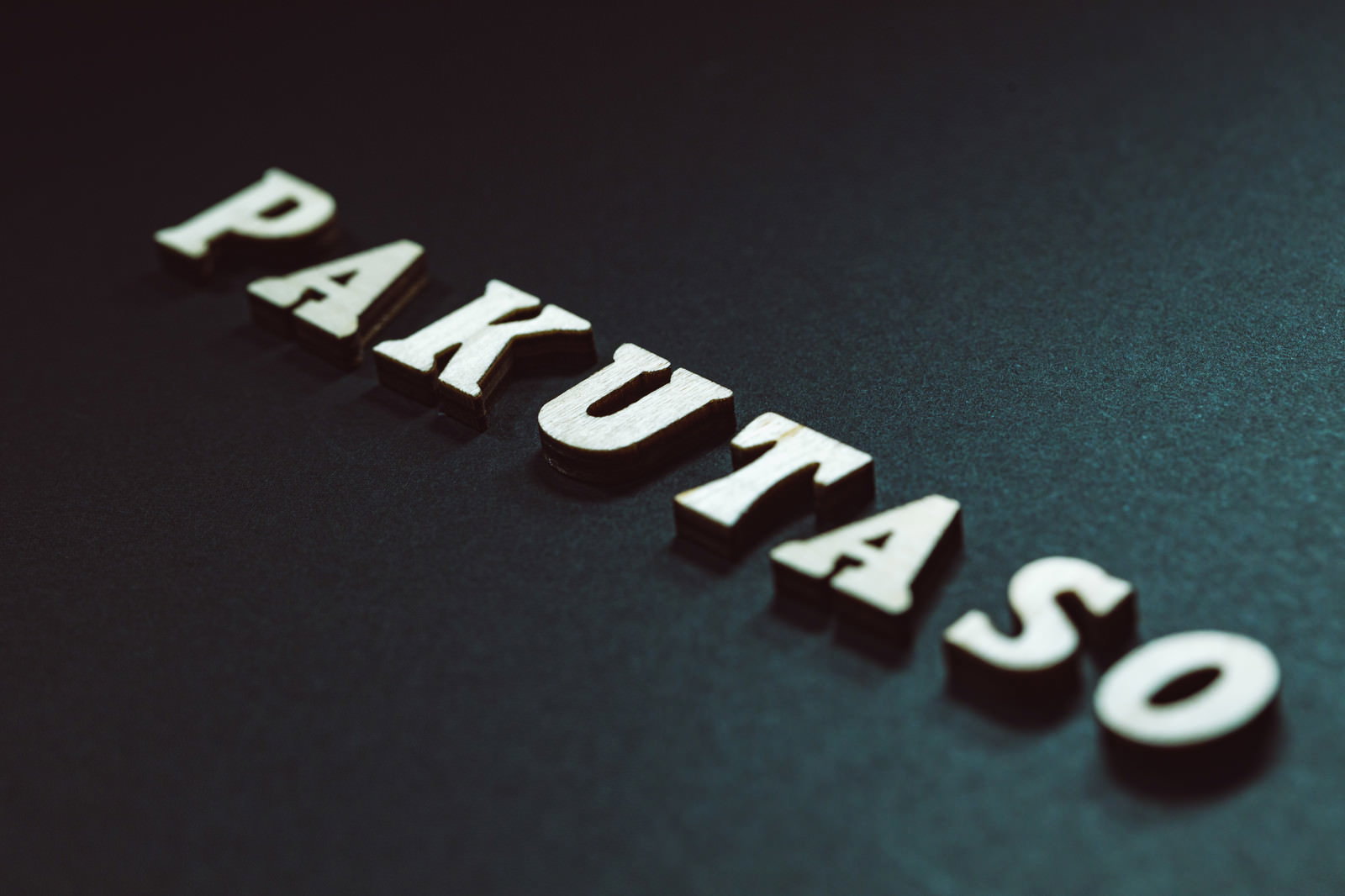 White, three-dimensional PAKUTASO text floating against a dark gradient background