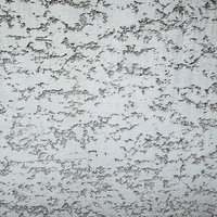 まばらに隙間の空いたグレーのコンクリート壁テクスチャーの写真