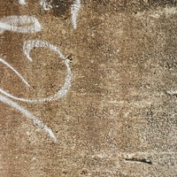 落書きが残る古いコンクリートの壁のテクスチャーの写真