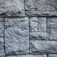 グレーの石積み調タイルで構成された壁面のテクスチャーの写真