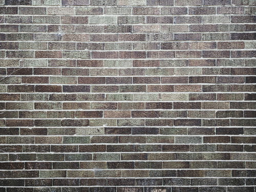 色あせたレンガタイルの壁のテクスチャー