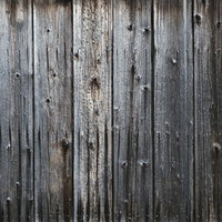 古い木目の板で作られた風化した壁のテクスチャーの写真