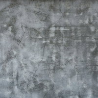 ひび割れや凹凸が目立つボコボコなコンクリート壁のテクスチャーの写真