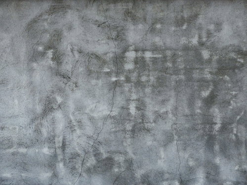 ひび割れや凹凸が目立つボコボコなコンクリート壁のテクスチャー