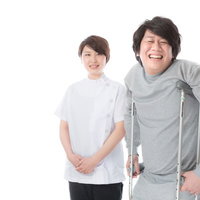 松葉杖でリハビリテーション中の患者と理学療法士の写真