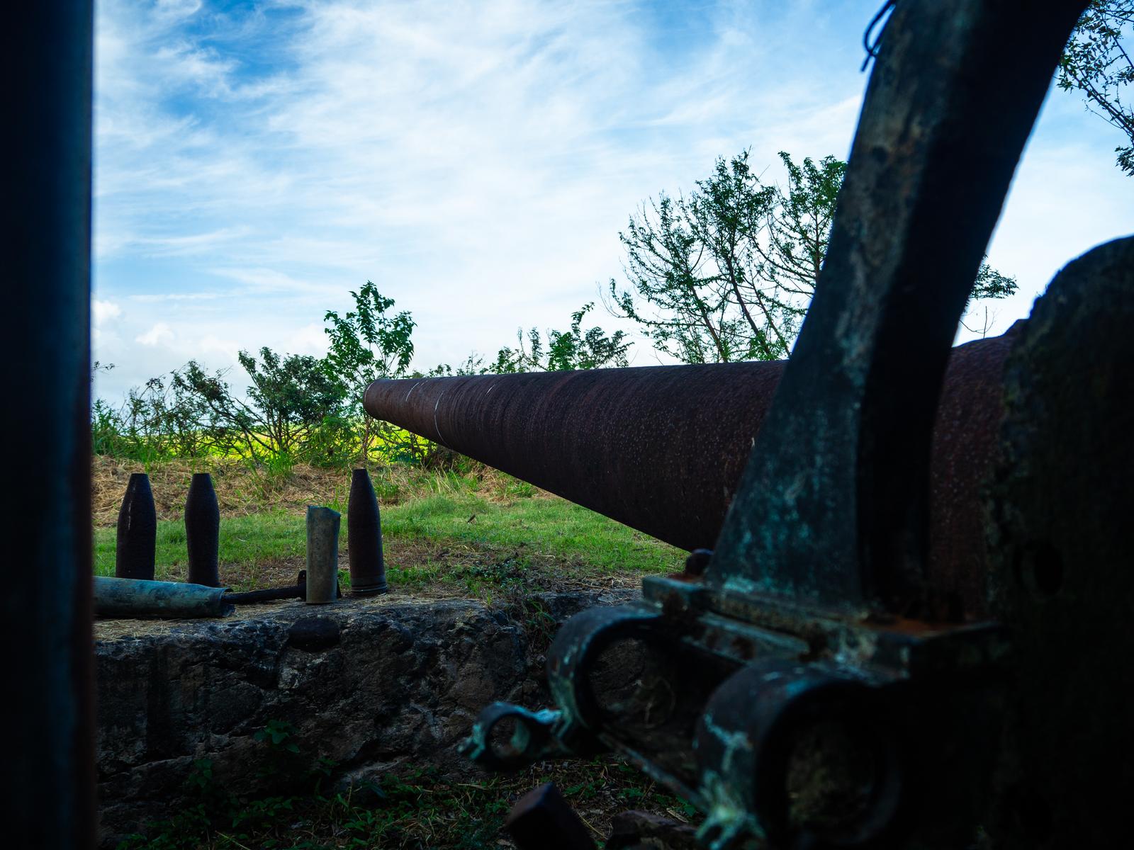 Close-up view of weathered cannon barrels at the Iwo Jima battlefield site