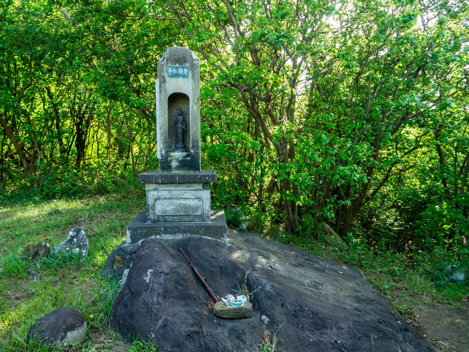 Memorial cenotaph of the Southern Kannon in Iwo Jima surrounded by lush green forest